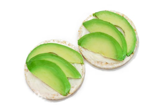 Rice Cake Sandwiches with Fresh Avocado and Cream Cheese Isolated on White. Easy Breakfast. Diet Food. Quick and Healthy Sandwiches. Crispbread with Tasty Filling. Healthy Dietary Snack Isolation photo