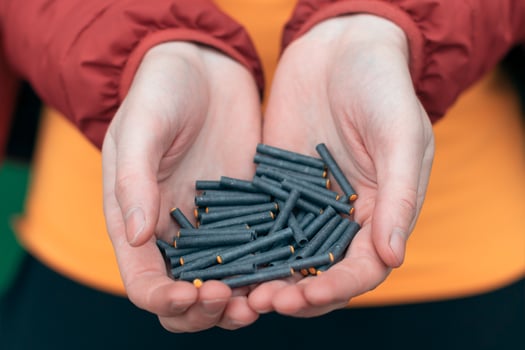 Man Holding Small Black Firecrackers in his Hand. Guy Getting Ready for New Year Fun CloseUp Shot photo