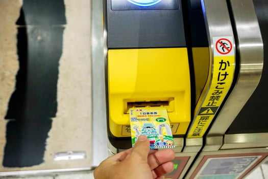 Osaka City, Japan, 2018 - Closeup hand of people insert subway ticket in the entrance automatic ticket machines at numba subway station, Osaka, Japan. photo
