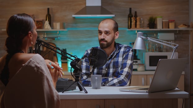 Man interviewing woman vlogger in home studio for podcast. Creative online show Onair production internet broadcast host streaming live content, recording digital social media communication photo
