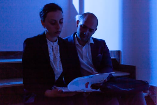 Stressed tired businesswoman helping coworker with deadline doing overtime. Colleague entrepreneur working late together in evening at corporate job sitting on staircase, explaining difficult finance project. photo