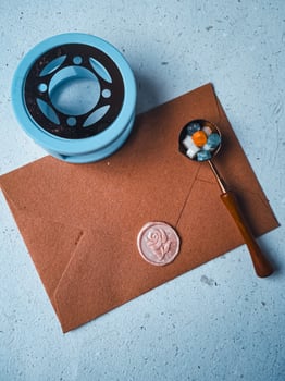 a vertical shot of wax coin with ribbon, wax bead on grey surface photo