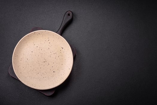 Bumpy empty ceramic plate on a textured concrete background photo