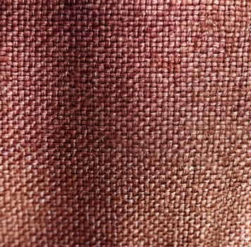 AI generated a very close up photo of a fabric texture with red and brown color tones,