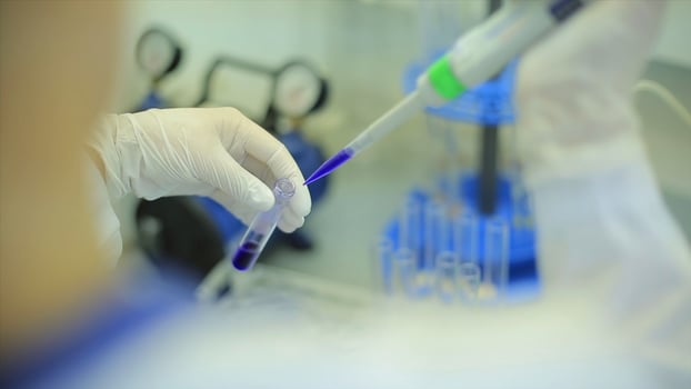 Test tubes closeup. Medical equipment. Close-up footage of a scientist using a micro pipette in a laboratory. Laboratory technician injecting liquid into a microtiter plate. Test tubes. Small depth of photo