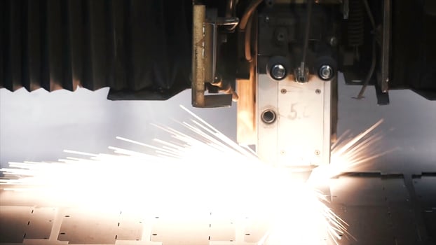 Laser machine cutting of sheet metal. Clip. Sparks fly from laser by automatic cutting CNC, PLC machine photo