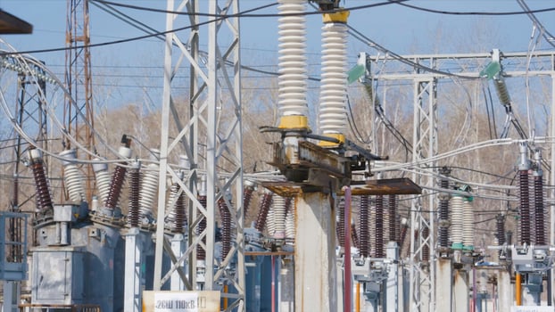 Many power poles in substation. Action. Electric substation with powerful equipment and transformers working in winter. Winter clear day at electric power station photo