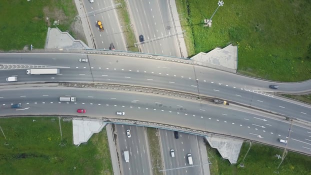 Elevated expressway. Clip. Top view at curves and lines of city highway. The curve of suspension bridge. Background scenic road photo