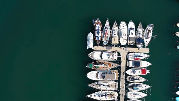 Aerial view of large and small yachts and sailboats moored at the quay. Action. Top view of Boats in Procida, Italy photo