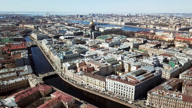 Top view of old town standing on river. Beautiful city with old buildings and houses standing at river channels passing through city photo
