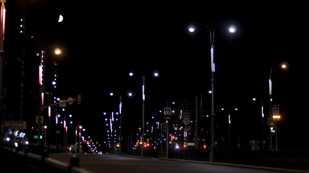Night city landscape of the empty road lit by countless lanterns, romance of summer night concept. Stock footage. City center in the late evening. photo