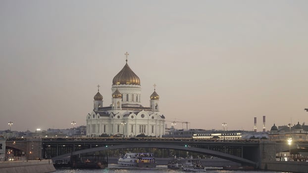 Aerial view of beautiful old cathedral building and Moscow river on sunset sky background. Action. Big churches with golden domes and the bridge, concept of architecture. photo