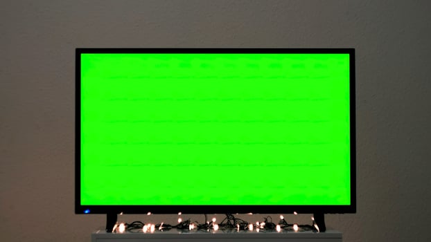 TV Green screen in living room. Concept. Chroma key screen for advertising. photo