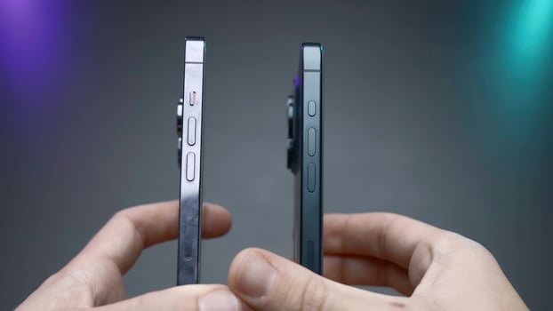USA, New York - September 15, 2023. Comparison of new iPhones. Action. Blogger compares latest versions of iPhones 14 and 15 pro. Comparison of external design of iPhones 14 and 15 pro photo