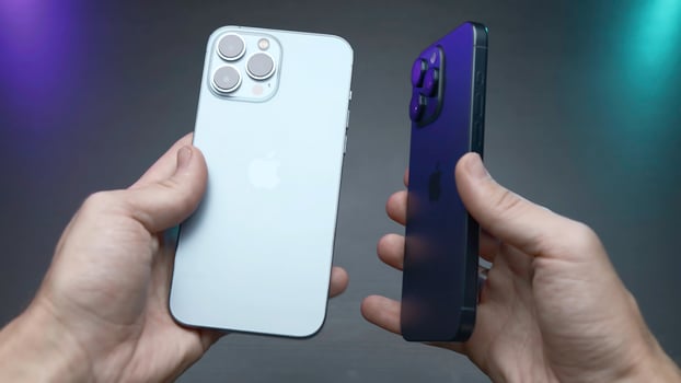 USA, New York - September 15, 2023. Comparison of new iPhones. Action. Blogger compares latest versions of iPhones 14 and 15 pro. Comparison of external design of iPhones 14 and 15 pro photo
