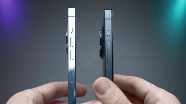USA, New York - September 15, 2023. Comparison of new iPhones. Action. Blogger compares latest versions of iPhones 14 and 15 pro. Comparison of external design of iPhones 14 and 15 pro photo