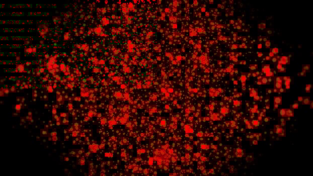 Abstract shining red particles flying on a black background. Motion. Tiny particles looking like snowflakes. photo