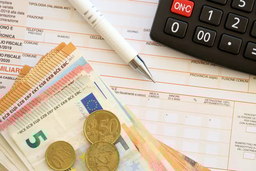Filling italian tax form process with pen, calculator and euro money bills close up. Tax paying period photo