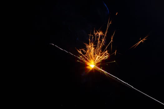 A lit sparkler showing bright sparks photo