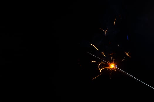 A lit sparkler showing bright sparks photo