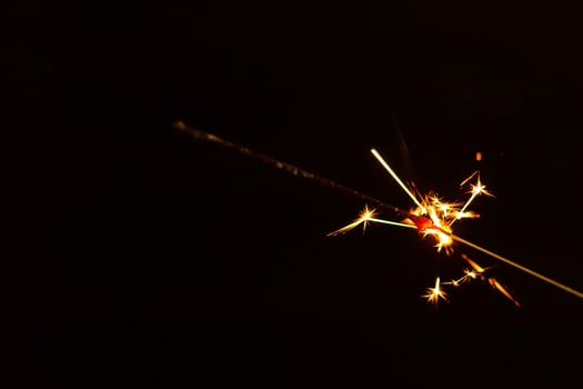 A lit sparkler showing bright sparks photo