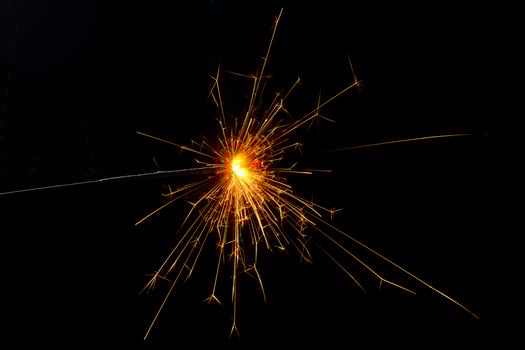 A lit sparkler showing bright sparks photo