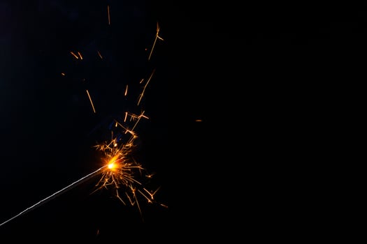 A lit sparkler showing bright sparks photo