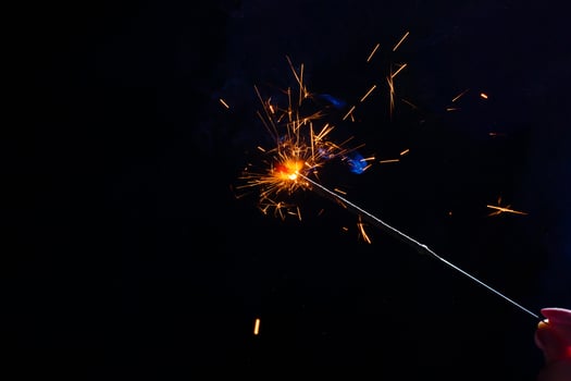 A lit sparkler showing bright sparks photo