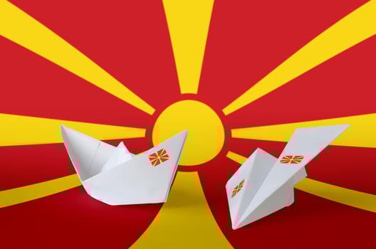 Macedonia flag depicted on paper origami airplane and boat. Handmade arts concept photo