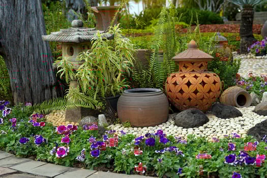 garden decoration with Japanese lanterns, Pottery jars of various shapes are arranged in cascades and decorated with various plants, flowers and garden stones. photo