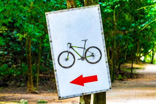 Rent a bike sign arrow information board direction in Coba Ruins. photo