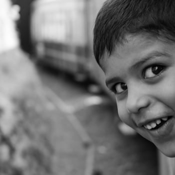 Little Boy travelling in Toy Train moving on mountain slopes, beautiful view, one side mountain, one side valley moving on railway to the hill, among green natural forest. Toy train Shimla photo