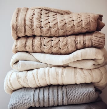 AI generated knitted sweaters in white, grey and beige, photo