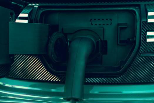 Closeup of charger connector connected to electric car. photo