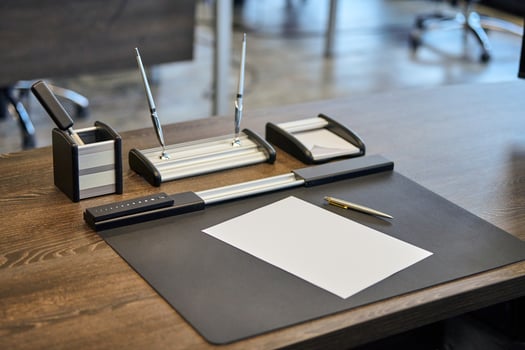 Modern office work place in large corporation. Comfortable work table with stationery, leather computer chair. Boss, chief, supervisor or head of company working place. photo