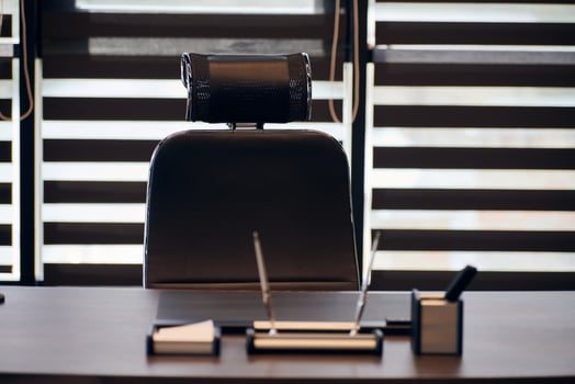 Business office workplace. Work place for chief, boss or other employees. Table and comfortable chair. Light through the half open blinds photo