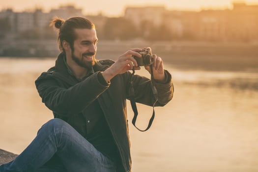 Handsome modern businessman enjoys photographing city.Toned image. photo