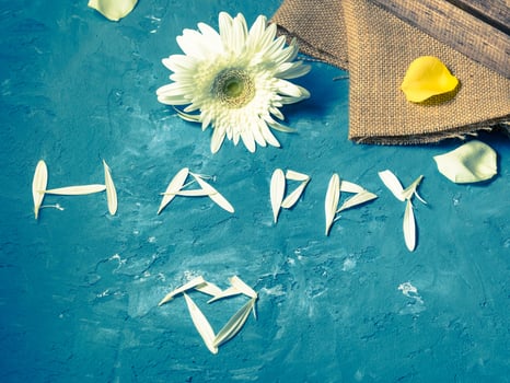 Word happy written with petals photo