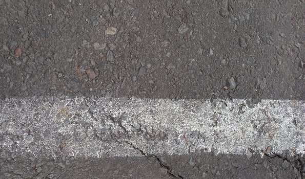 Grey asphalt with white lines. Rough cement road surface. Cracked asphalt road background. photo