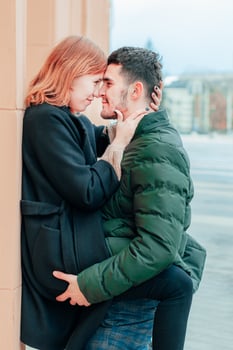 Happy Loving Couple Smiling and Hugging on the Street. Two Happy People Love Story Medium Shot Portrait photo