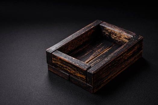 Empty rectangular wooden cutlery box on textured concrete background photo