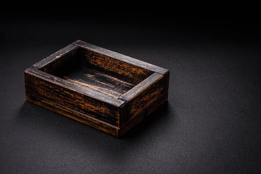 Empty rectangular wooden cutlery box on textured concrete background photo