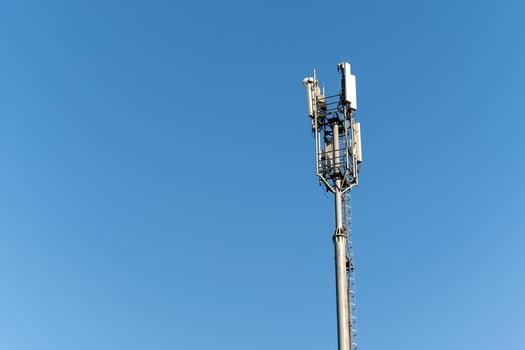 Telecommunications Tower Standing Tall Against Clear Blue Sky photo