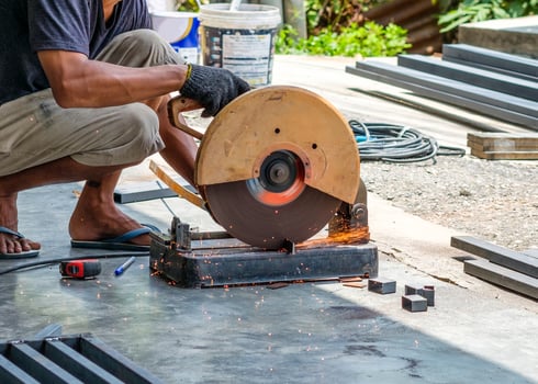 Craftsman sawing steel with disk grinder photo