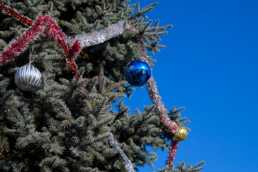 Decorations New Year tree. Tinsel and toys, balls and other decorations on the Christmas Christmas tree standing in the open air. photo