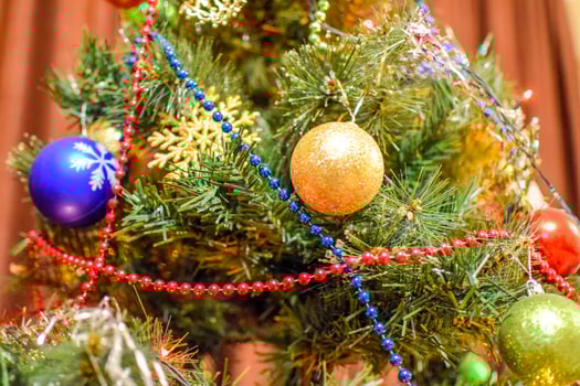 Decorations New Year tree. Tinsel and toys, balls and other decorations on the Christmas Christmas tree standing in the open air. photo