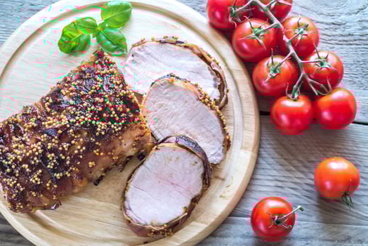 Baked pork meat wrapped in bacon photo