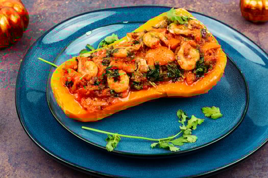 Baked pumpkin stuffed with vegetables and shrimp. photo
