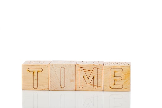 Wooden cubes with letters time on a white background photo