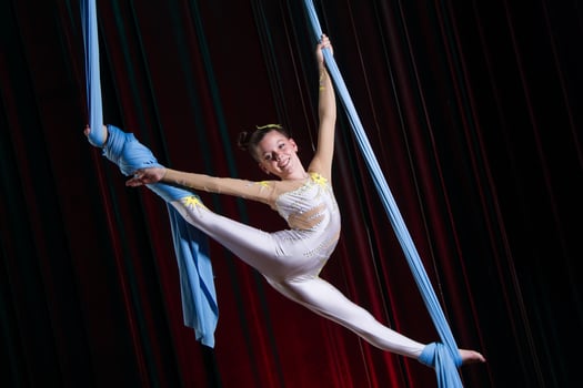 Circus artist acrobat performance on canvases. The girl perform acrobatic elements in the air. photo